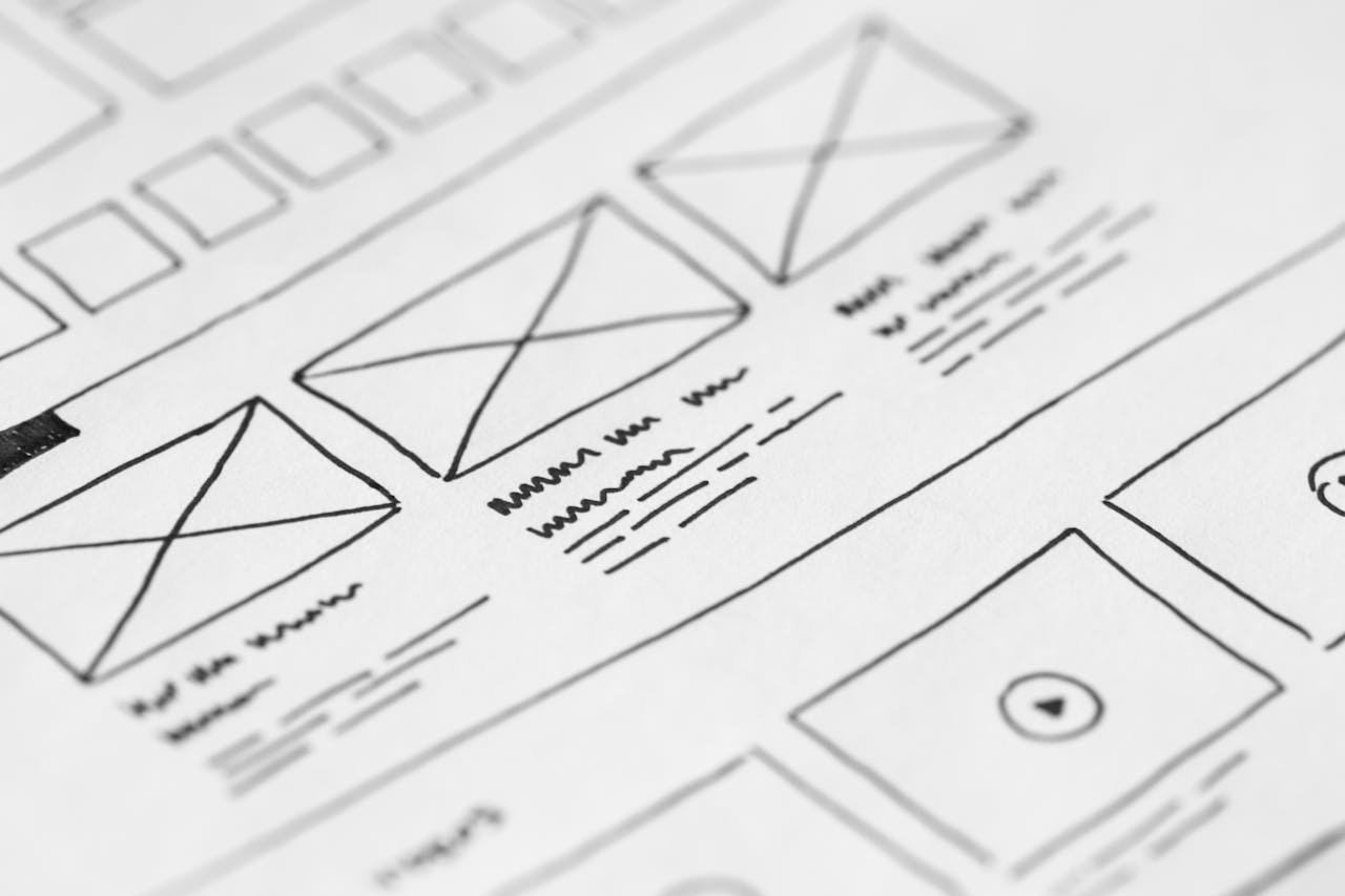 about-me-01 Detailed close-up of a hand-drawn wireframe design on paper for a UX project.